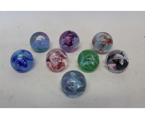 Eight Caithness 'Mooncrystal' glass paperweights