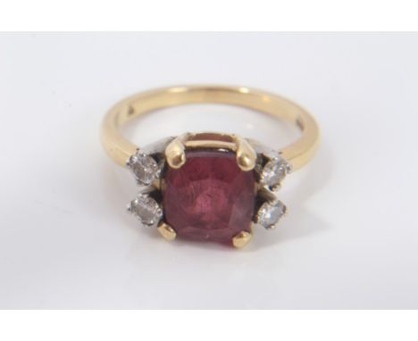 Ladies gold (18ct) ring, the central cushion cut pink / red tourmaline flanked by four diamonds in claw setting
