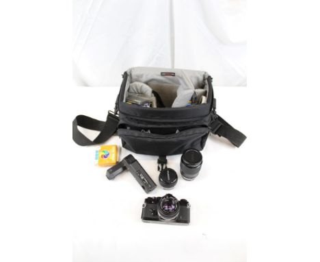 Three manual focus 35mm SLR cameras - comprising Olympus OM4 and OM1 and a Canon A1, together with a Rollei A26 camera and va