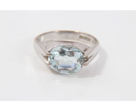 White gold (9ct) aquamarine ring with an oval mixed cut aquamarine in four-claw contemporary-style setting.  Ring size P½ CON