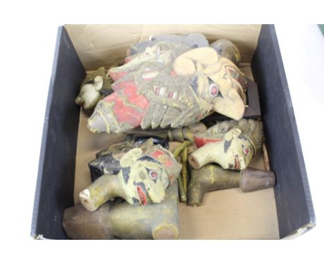 Selection of wooden Asian puppet heads and torsos and limbs