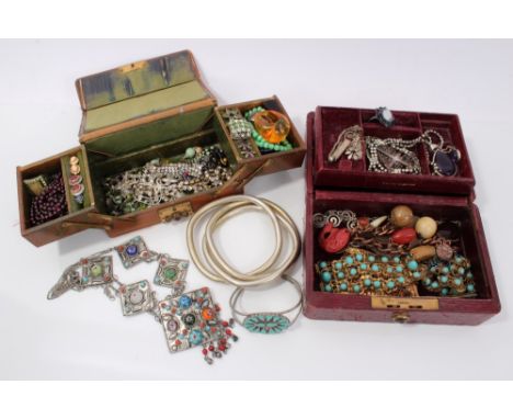 Two old leather jewellery boxes containing paste set jewellery, silver and amethyst pendant, other white metal jewellery, etc