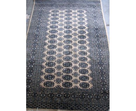 Three rugs comprising Chinese blue ground, mocha ground Afghan with repeating medallions and a Turkish cream ground rug