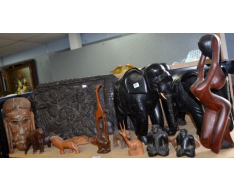 Two large wood carved elephants, carved plaque of a gentleman amongst fruit, together with various wood  figures and animals.