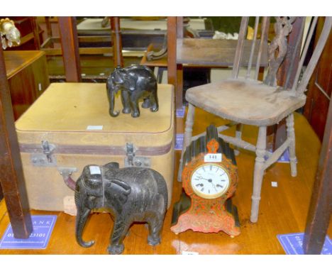 A Boulle style clock together with a child's chair, a pair of ebonised elephants and a travelling case.