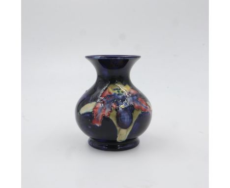 Moorcroft vase in the Orchid pattern on cobalt blue ground. H: 9.5cm. UK P&amp;P Group 1 (£16+VAT for the first lot and £2+VA