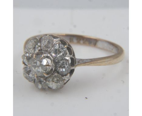 Victorian 18ct gold diamond cluster ring, nine old cut diamonds held by fine claws, centre diamond being raised above the oth