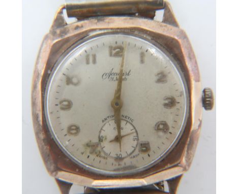 ACCURIST: 9ct gold gents manual wind wristwatch, with 1957 Evening Express inscription, on an expanding steel bracelet. UK P&