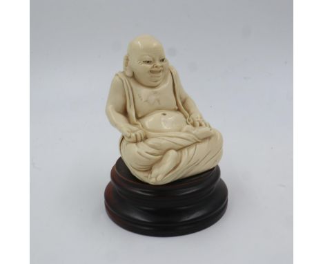 Resin seated figure of Buddha on a turned hardwood base, overall H: 16 cm. UK P&amp;P Group 2 (£20+VAT for the first lot and 