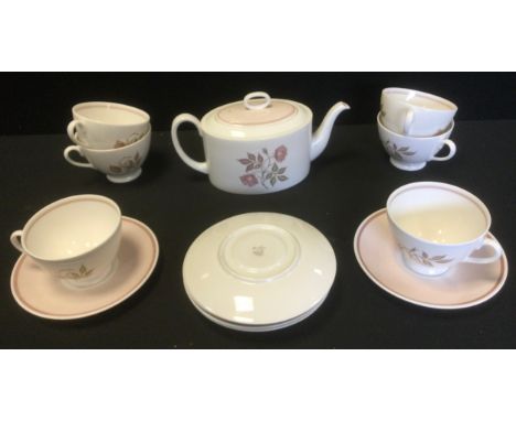 A Susie Cooper bone china tea service, for six, printed with rose spray, washed in pink, comprising teapot and cover, teacups