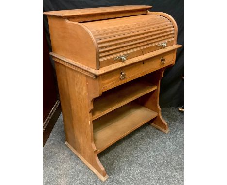 An early 20th century oak roll-top desk of small proportions, 101cm high x 76cm wide x 51cm deep, roll-top desk above a singl