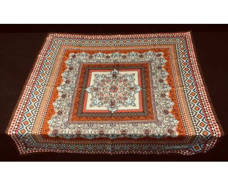 A Hermes Paris scarf, all over geometric decoration in tones of blue, brown, russet, red and cream, 88cm square. 