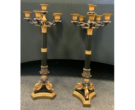 A pair of modern bronzed and gilt metal six light five branch table candlesticks, in the Regency style, 64cm high 