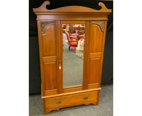 An early 20th Century Mahogany wardrobe, crested pediment, central door with bevelled mirror, carved panels, single long draw