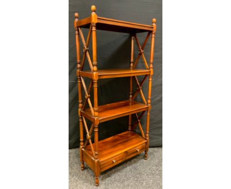 A Reproduction Mahogany Bookcase of small proportions, turned columns and x-frame stretchers, three shelves above a pair of s