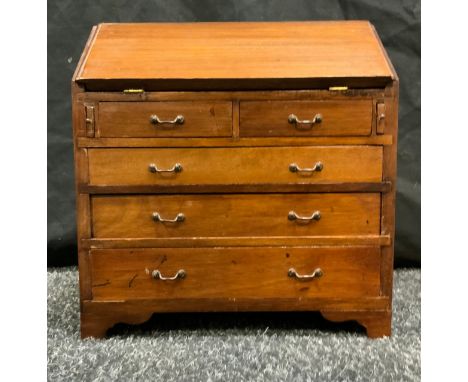 An Apprentice Cabinet Maker's miniature mahogany Bureau; fall front enclosing four short drawers and pigeon holes, above a pa