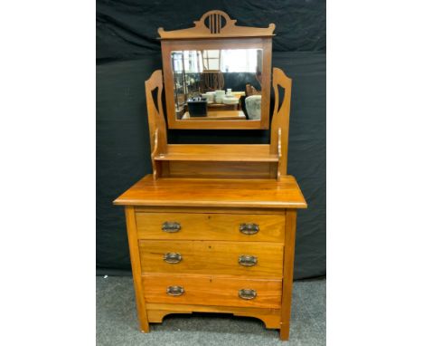 An Arts &amp; Crafts walnut dressing table, central rectangular mirror above a short shelf, rectangular top above three long 