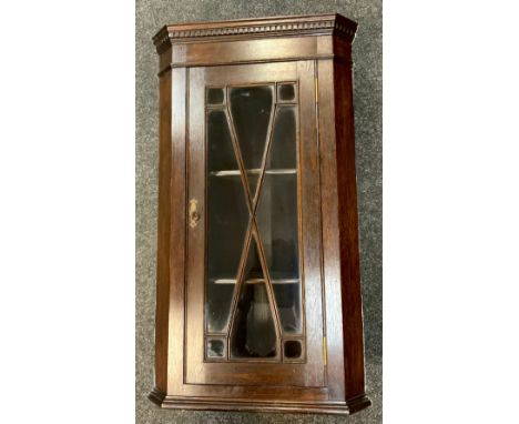 An early 20th century oak wall hanging corner cupboard, glazed door, made from timber from Taxel Church, 79cm high, 43cm wide