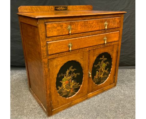 An Early 20th century oak cabinet chest, two long drawers above a pair of cabinet doors with Chinoiserie lacquer work panels,