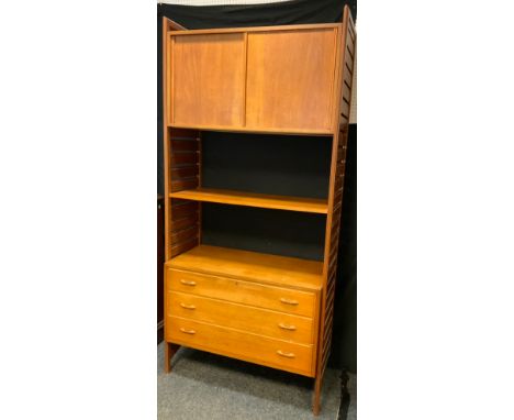 A mid 20th century Laddarax type retro teak wall hanging side unit, with sliding cupboard above open shelf and three drawers 