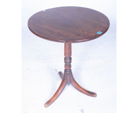 A 19TH CENTURY MAHOGANY TRIPOD TABLECircular top on ring turned column over outswept supports 58cm diameter; 70cm high