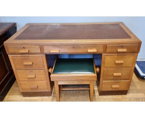 A light oak desk with leatherette top, three frieze drawers over three drawer pedestals, 68cm x 138cm x 77cm, together with s