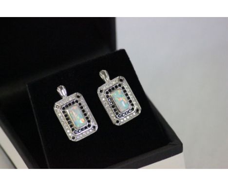 A pair of silver cz and opal paneled earrings