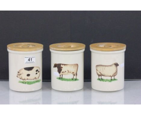Three ceramic kitchen storage jars with wooden lids and a Farmyard animal theme, maker marked "Pimpernel" to base