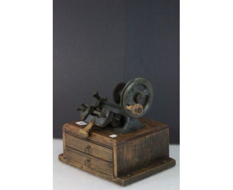 A vintage Yale key cutting machine mounted on oak base with two drawers with keys etc