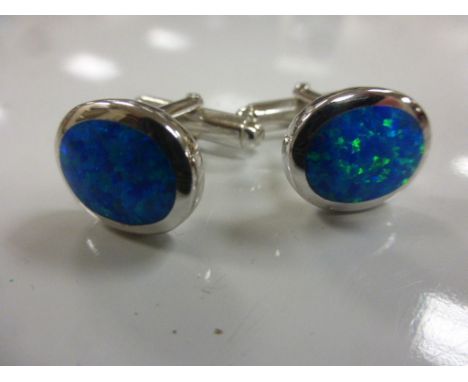 A pair of silver and blue opal cufflinks 