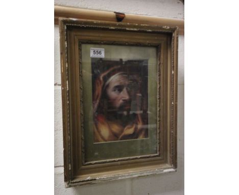 A gilt framed oil portrait of a man in a robe and head gear 