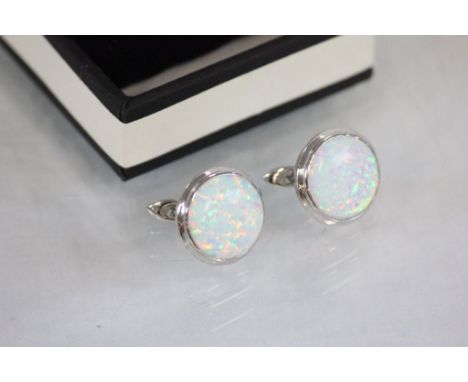 A pair of large silver and opal stud earrings 