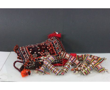 Four Maasai bead and sea shell amulet flasks and carpet style bag