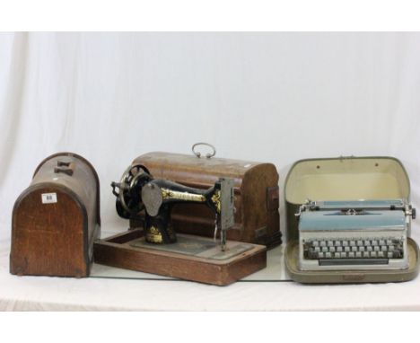 Two vintage wooden cased sewing machines to include Singer and a cased Bluebird typewriter