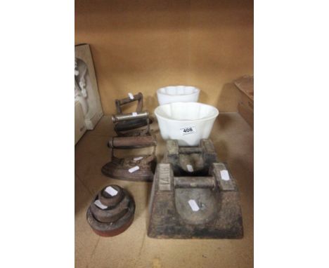 Two ceramic Jelly moulds, three flat irons and five vintage weights