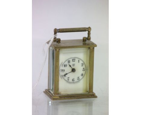 A miniature carriage clock, Waterbury Clock Co. USA, cream enamel dial with black Roman numerals (af)