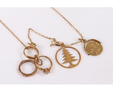 9 carat gold necklace with charms, with a miniature ring with cubic zirconia, other miniature rings, a tree charm and a disc 