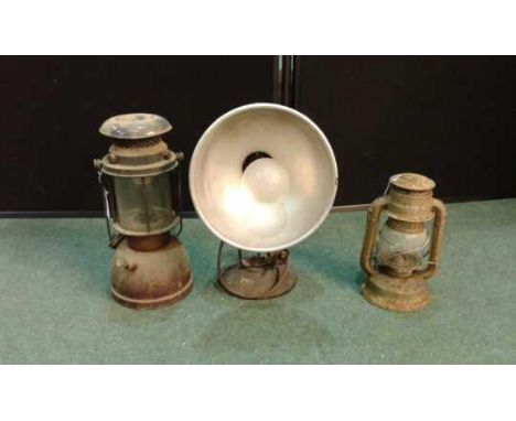 Two oil lamps together with a flood light (3)