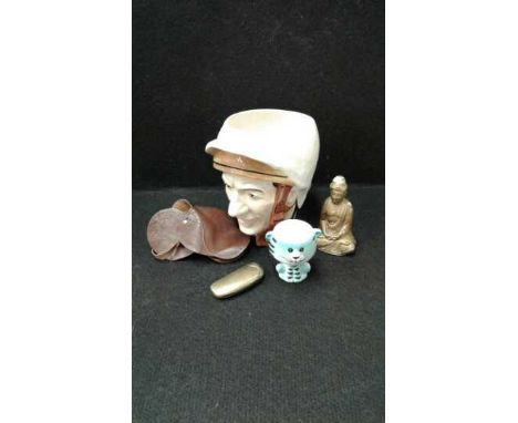 Denhams Art Limited edition Toby Jug of Lester Piggot numbered 891/1000, a gold painted plaster Buddha, cat egg cup, miniatur