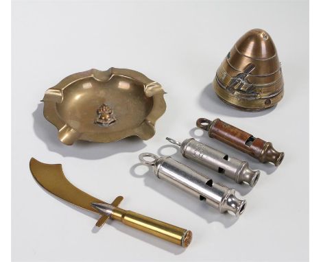 A WW1 brass percussion fuse together with a brass Hudson of Birmingham Metropolitan whistle, an Acme Scoutmaster whistle, an 