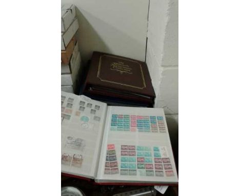 Four albums to include two Stamp albums Philatelic Numismatic Collection and another stamp album, a Post card album and a Pho