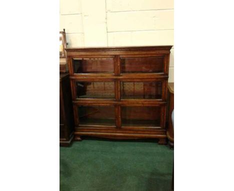 Oak sectional bookcase with dentil pediment and six glazed doors on ogee bracket feet, 122cm wide