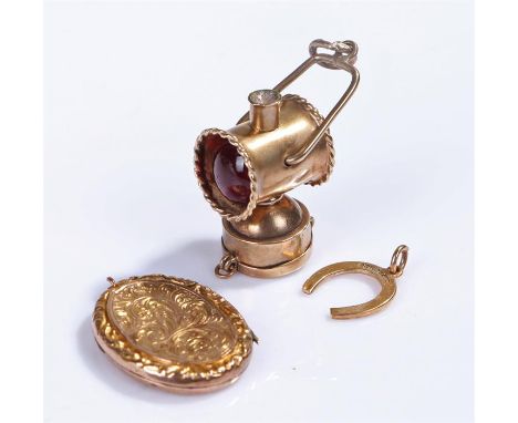 9 carat gold horse shoe pendant, together with a yellow metal charm as a lantern and a locket, (3)