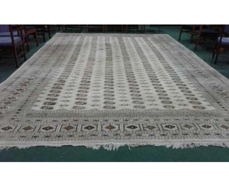 Large Pakistani carpet, with rows of geometric design, 525cm long, 460cm wide