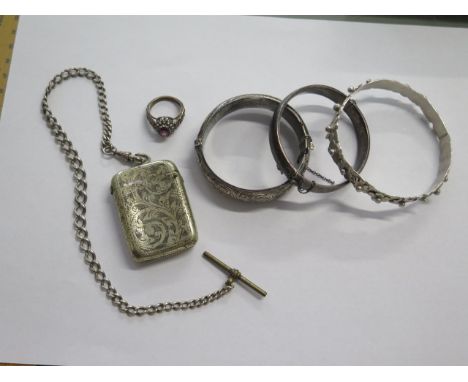 A silver vesta on a watch chain, three silver hallmarked bangles, a silver ring, and a silver bracelet, total weight approx 5