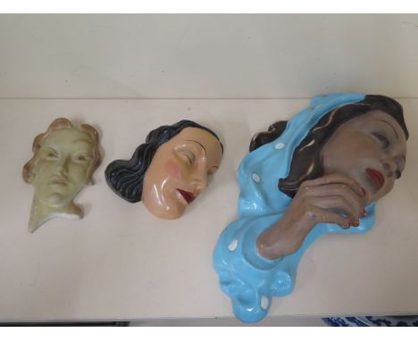 Two plaster Art Deco lady wall masks and a ceramic mask, largest 45cm, some repainting and restoration to largest and small c