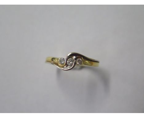An 18ct hallmarked white and yellow gold three stone diamond ring, total 0.25ct ring, size R, approx 4.4 grams, some small we