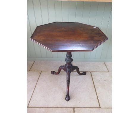 A well carved mahogany tripod table with an octagonal on piece bird cage action top, 74cm tall x 74cm wide 