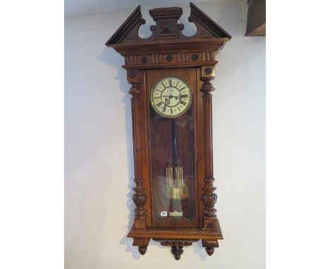 An 8 day twin weight striking walnut wall clock, 130cm tall x 55cm wide in working order 