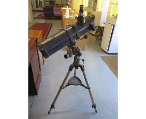 A Celetron Astro Master 130 telescope on tripod 
